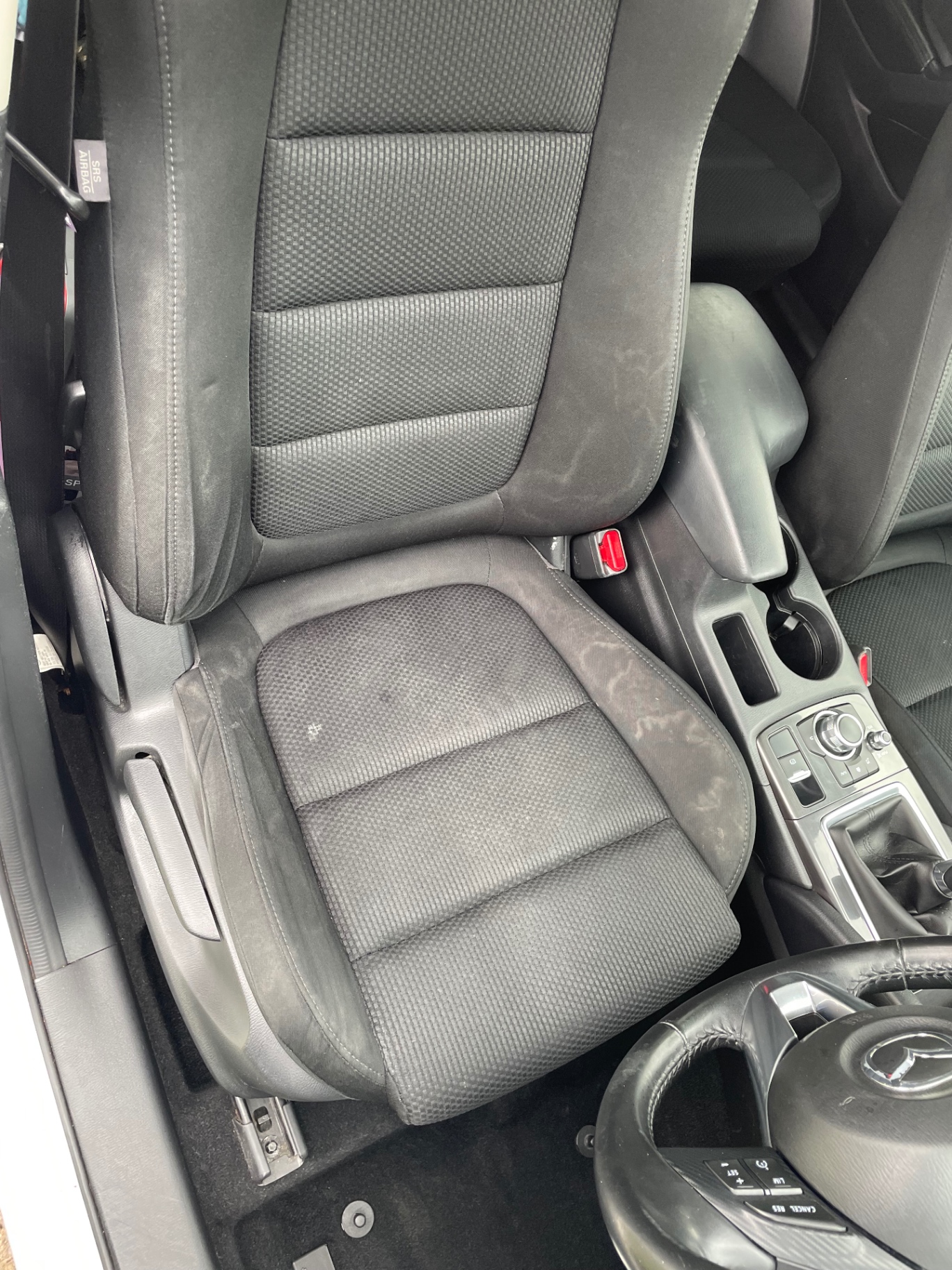 Stained fabric car seat before an M&M Deluxe valet