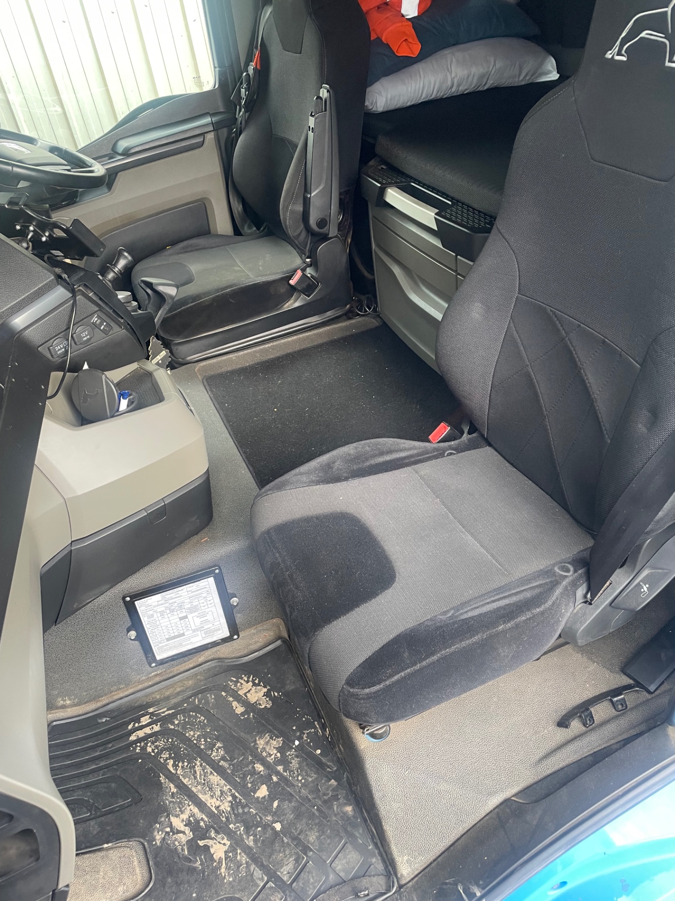 Dirty lorry cab seats and floor before an M&M Deluxe valet