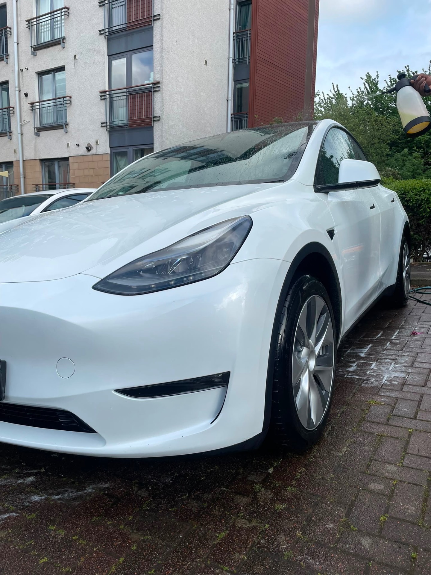 White Tesla Model Y being snow foamed
